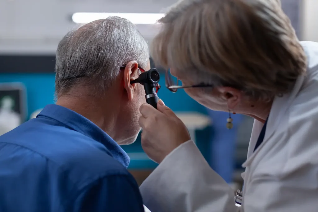 Rubicare audiology provider examines the patient's ear.