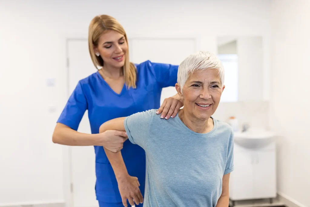 Rubicare Chiropractic provider working with female patient's shoulder.